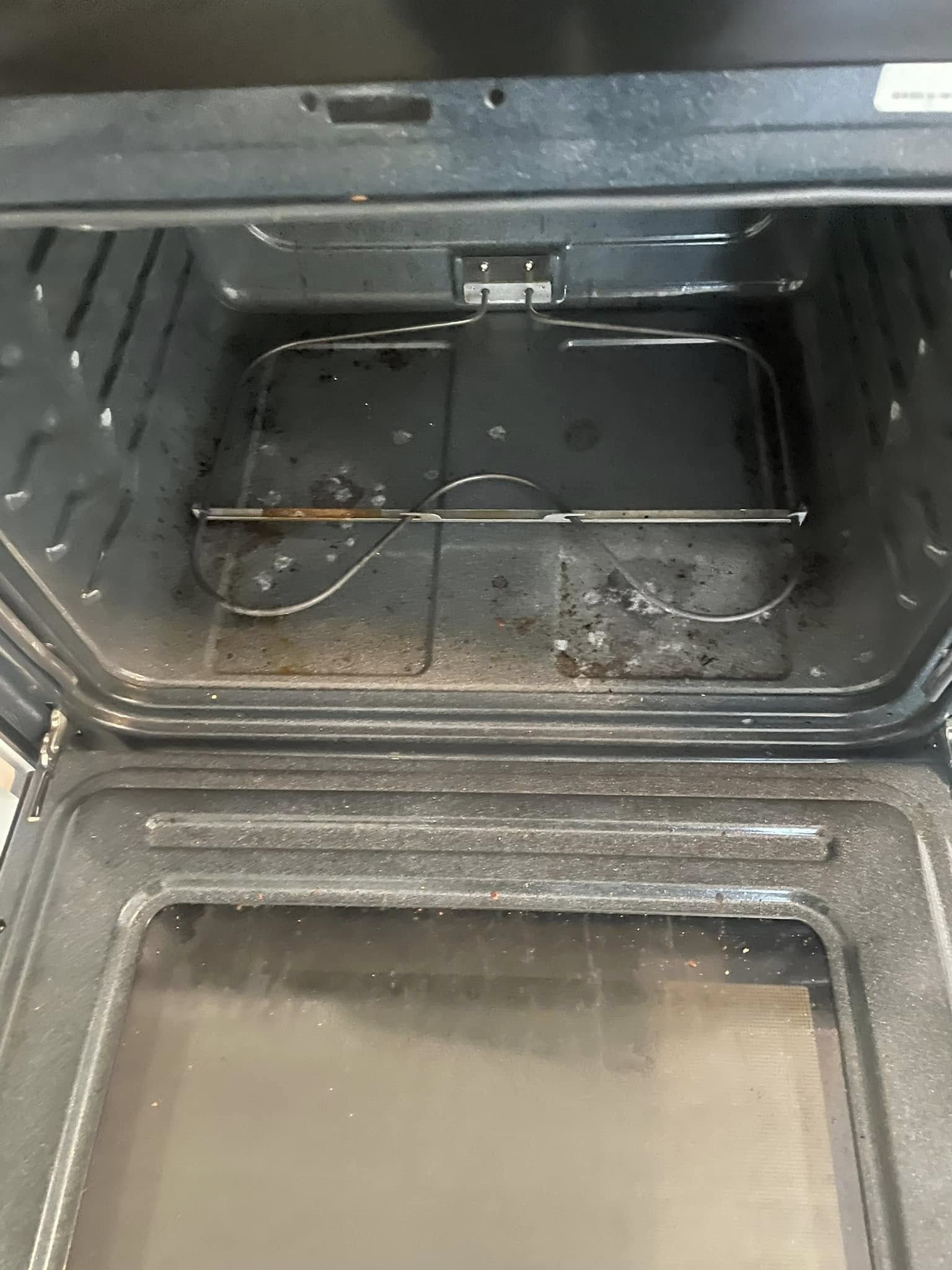 Oven before deep clean, heavily stained with baked-on grease